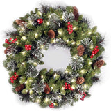 National Tree Company 24 in Pre-Lit Crestwood Spruce Artificial Christmas Wreath, Christmas Decoration with Glitter, Pinecones, Red Berries, 50 Clear LED Lights, 160 Tips, Timer, Green