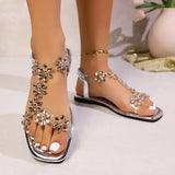 A pair of women's square-toe flat sandals, stylish silver sandals adorned with floral decorations 2026