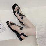 A pair of women's square-toe flat sandals, stylish silver sandals adorned with floral decorations 2026