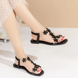 A pair of women's square-toe flat sandals, stylish silver sandals adorned with floral decorations 2026