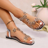 A pair of women's square-toe flat sandals, stylish silver sandals adorned with floral decorations 2026