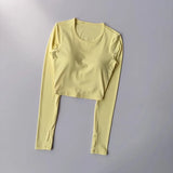 Women's long sleeved yoga suit sports top, high-end tight fitting hollow back fixed chest cushion