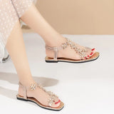 A pair of women's square-toe flat sandals, stylish silver sandals adorned with floral decorations 2026