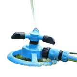 Blue Rotating Garden Sprinklers Watering Grass