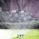 Blue Rotating Garden Sprinklers Watering Grass