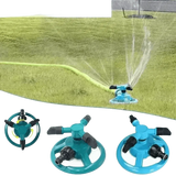 Blue Rotating Garden Sprinklers Watering Grass