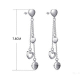 Long Dangling Heart Earrings in White Gold
